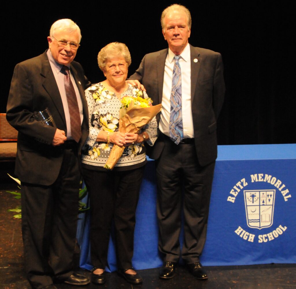 Memorial President John Browning, right, awarded the Distinguished Service Award to James and Janice Hummel for their more than 60 years of support to the high school.