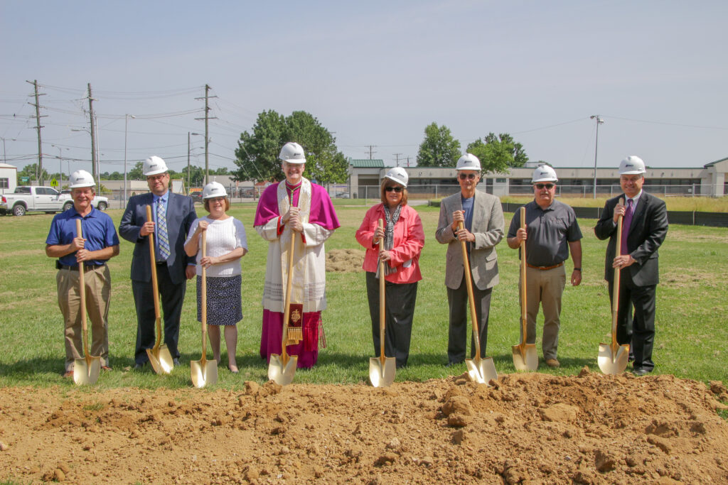 Preparing to turn the first shovels of dirt on the site of Catholic Charities of the Diocese of Evansville’s future home are Dan Ritter, left, Catholic Charities Building Committee chairperson; Mike Vogel, President of the Catholic Charities Board of Advisors; Catholic Charities Executive Director Sharon Burns; Bishop Joseph M. Siegel; Charline and Mike Buente of Buente-Buente Architects PC; Dan Jones of Danco Construction, Inc.; and Diocesan Chancellor and Chief Operating Officer Tim McGuire.