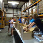 A Mission Evansville crew packs boxes for Tri-State Food Bank’s low-income senior citizen meal program, which serves over 1,200 people in need in Indiana and Illinois once a month.