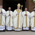 Photo by Kevin J. Kilmer The Most Reverend Joseph M. Siegel, Bishop Evansville, center poses with newly ordained Priests Fr. Luke Hassler, Fr. Martin Estrada, Fr. Juan Martinez, and Fr. Andrew Thomas, outside of St. Philip Church, Mount Vernon Saturday.
