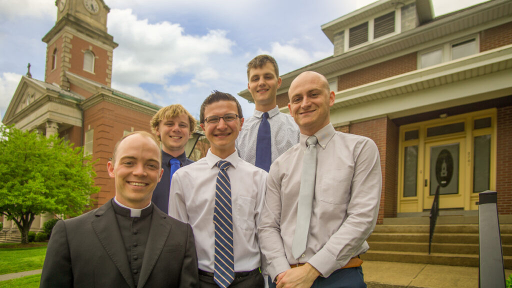 Father Tyler Tenbarge, left, stands in front of the Father Deydier House of Discernment at Sacred Heart Church with 2018-19 residents Ethan Dale, Michael Mosbey, Isaac Memmer and Clint Johnson. (Submitted photo)