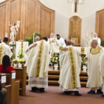 Photo by Kevin J. Kilmer The Priests of the Diocese of Evansville, greet their newly ordained Priests: Fr. Martin Estrada, Fr. Luke Hassler, Fr. Juan Martinez, and Fr. Andrew Thomas, Saturday, in St. Philips Church, Mount Vernon, Ind., following The Rite of Ordination.