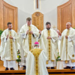 Photo by Kevin J. Kilmer The Most Reverend Joseph M. Siegel, Bishop of Evansville, is blessed by newly ordained Priests: Fr. Martin Estrada, Fr. Luke Hassler, Fr. Andrew Thomas, and Fr. Juan Martinez, Saturday, in St. Philips Church, Mount Vernon, Ind., following The Rite of Ordination.