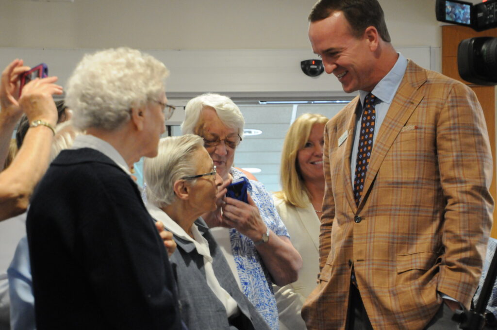Former Indianapolis Colts quarterback Peyton Manning chats with Daughter of Charity Sister Mary John Tintea after a press conference on Aug. 14 announcing the Peyton Manning Children’s Hospital brand expansion and new emergency room for kids at St. Vincent Evansville. The Message photos by Megan Erbacher