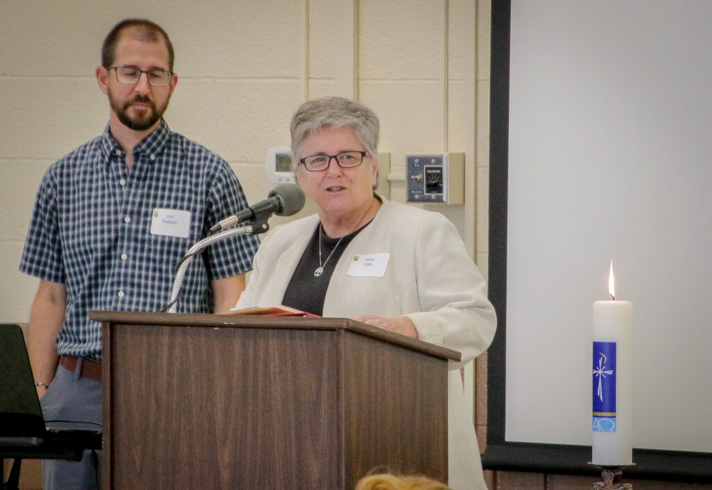 Joel Padgett, left Parich Catechetical Leader at St. John the evangelist Parish in Daylight, listens as
Diocesan Director of Catechesis Kathy Gallo welcomes attendees to the 2019 Formation Day Aug. 24 at
the Diocese of Evansville Catholic Center. Gallo urged attendees to approach the day – and their
ministries – with this question in mind: “How will what I do put people in touch with Jesus Christ?” The Message photos by Tim Lilley