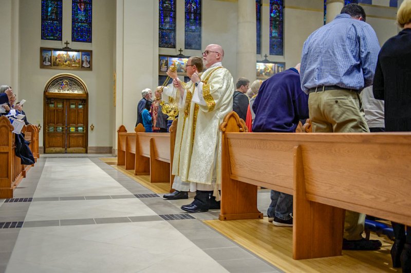 Deacons David Rice, left, of St. Benedict Cathedral Parish and Jay VanHoosier of St. John the Baptist Parish in Newburgh make their way throughout the cathedral, censing the cathedral and all those in attendance. The Message photo by Jay Hamlin