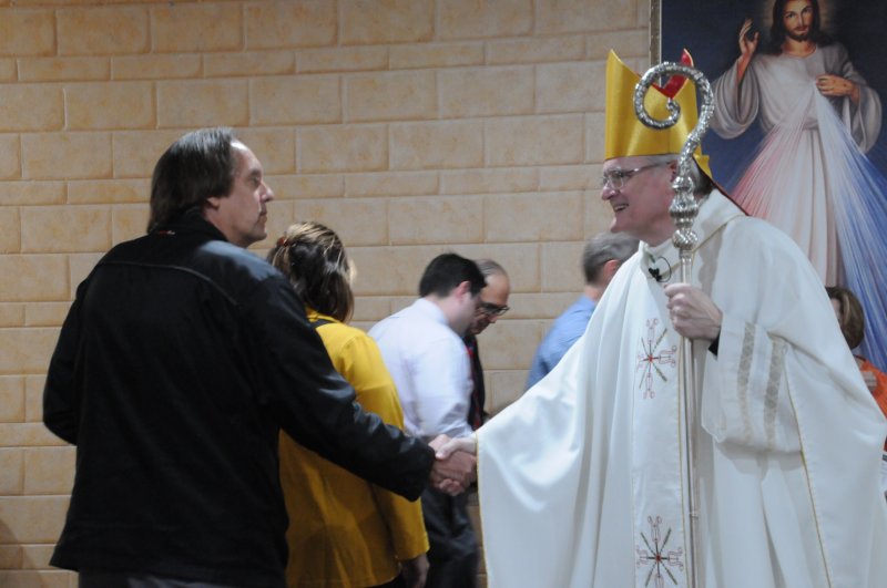 Bishop Joseph M. Siegel, right, greets people after this year’s Diocesan White Mass. More than 60 people attended the Mass, which is celebrated annually on or near the Oct. 18 Feast of St. Luke, patron of healthcare professionals. The Message photo by Megan Erbacher
