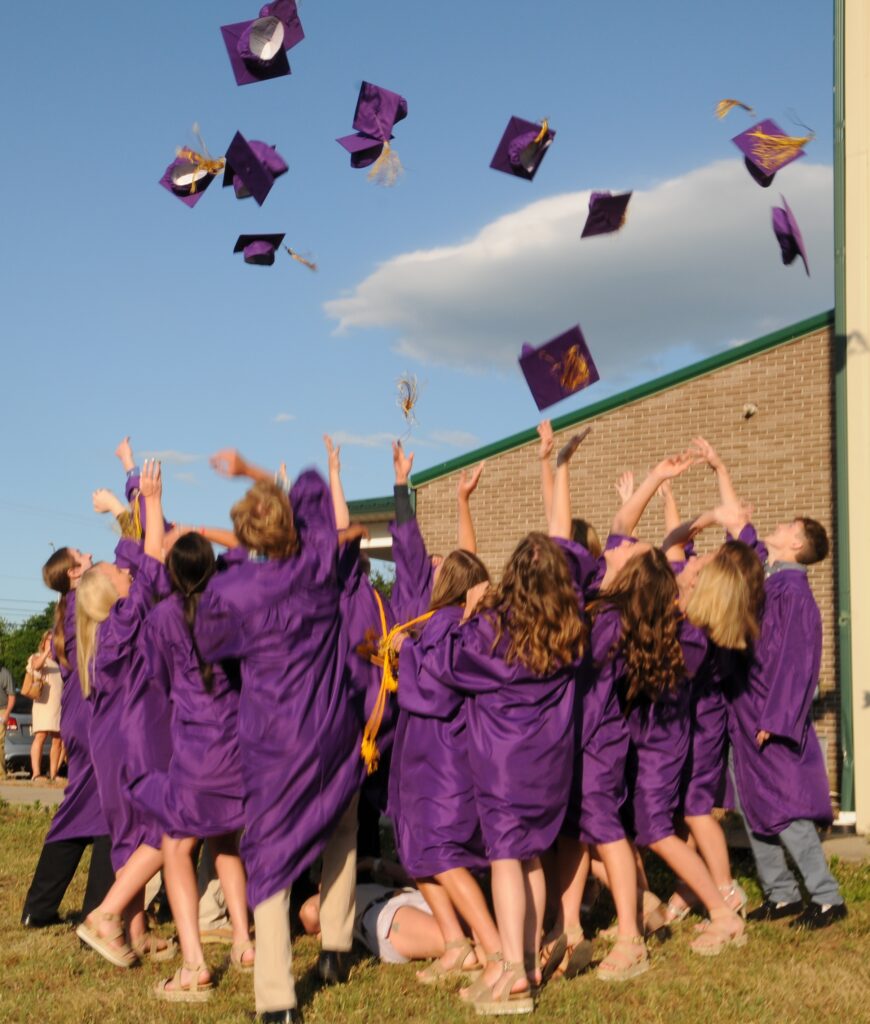 Members of Rivet’s Class of 2020 toss their caps in the air after the June 12 Commencement Ceremony at Highland Woods Community Center.  The Message photo by Megan Erbacher