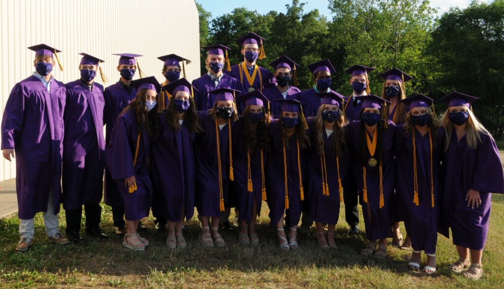 Members of Rivet’s Class of 2020 pose after graduation with CDC recommended facemasks to help prevent the spread of the coronavirus. The Message photo by Megan Erbacher