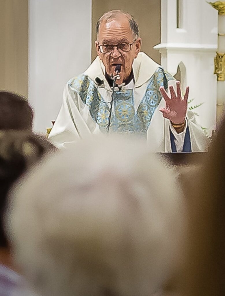 During his comments at the end of Mass, Father Erbacher commended all the parishioners and parish staffers who “worked so many hours beyond the call-of-duty … to carry us through.” Photo by Brescher Photography