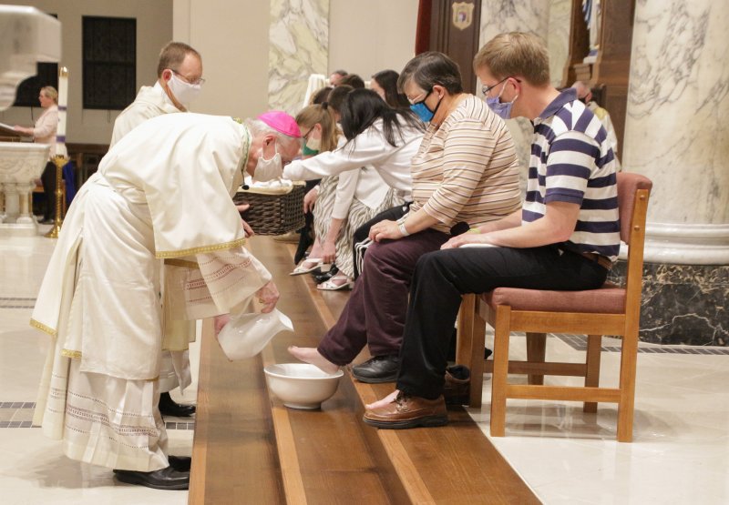 After the homily, Bishop Siegel washed the feet of 12 people who attended the Mass. The Message photo by Tim Lilley