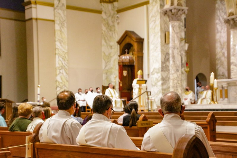 Deacons, in the foreground, listen to Bishop Siegel’s homily during the Chrism Mass. The Message photo by Tim Lilley