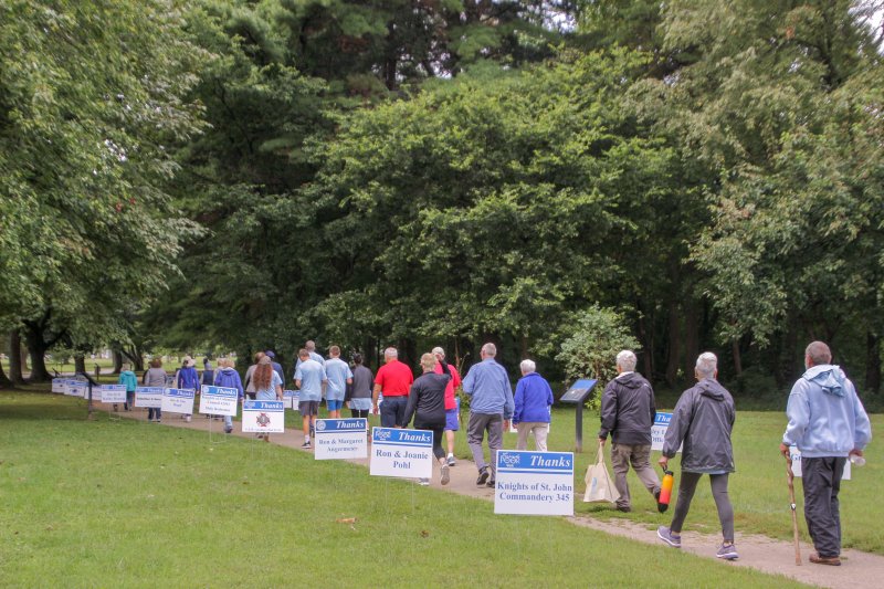 As they began the one-mile loop around the grounds of the Evansville State Hospital, walkers passed through a lane of signs recognizing sponsors. The Message photo by Tim Lilley