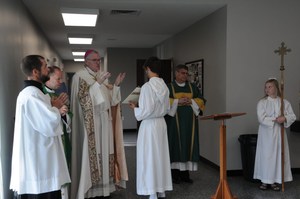 During his blessing, Bishop Joseph M. Siegel, third from left, said the building is something the Lord built through parish sacrifices, commitment in faith and hard work. Also pictured are Matt Miller, left, diocesan director of the Office of Worship, Father Tony Ernst, administrator of St. Philip Neri Parish, and Deacon Paul Vonderwell, fifth from left. The Message photo by Megan Erbacher