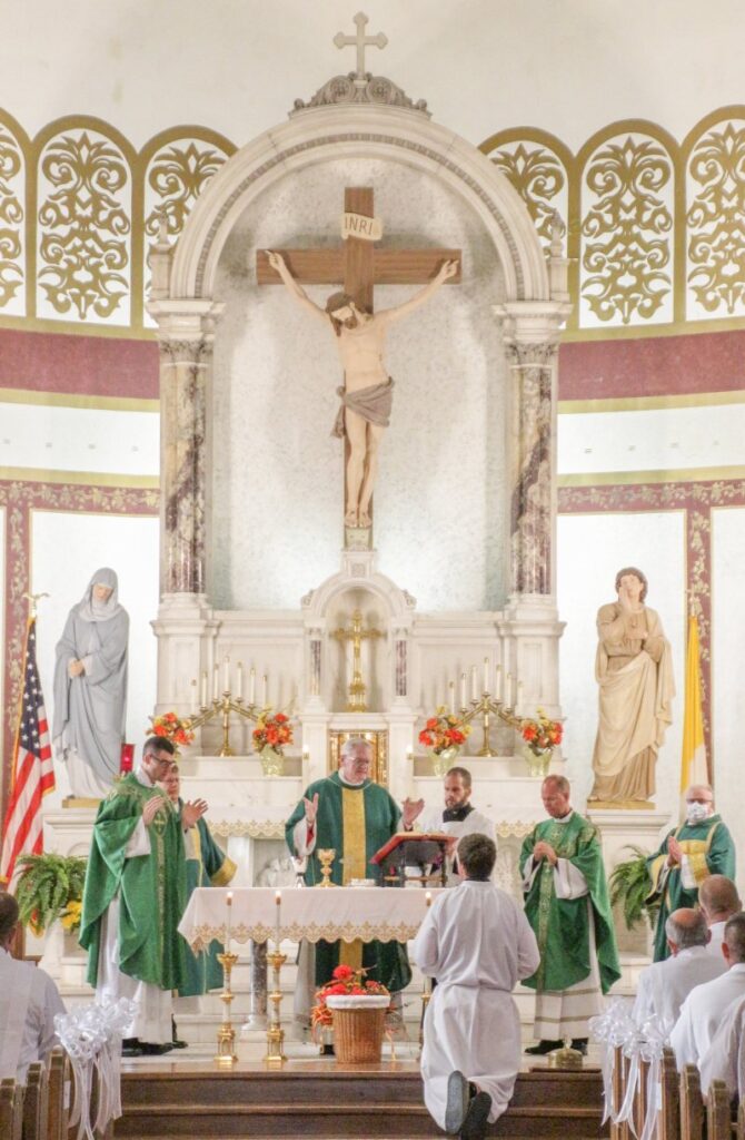 Joining Bishop Siegel, center, at the altar during the Mass
were Father Garrett Braun, left, parochial vicar of St. Francis
Xavier Parish and St. Philip Neri Parish in Bicknell; Deacon
Paul Vonderwell, who serves St. Francis Xavier and St. Philip Neri parishes; Diocese of Evansville Director of Worship Matt Miller, who served as master of ceremonies; Father Tony Ernst,
administrator of St. Francis Xavier and St. Philip Neri parishes; and Deacon Thomas Evans of St. Matthew Parish in Mount Vernon, who serves as director of the permanent diaconate for the Diocese of Evansville. The Message photo by Tim Lilley