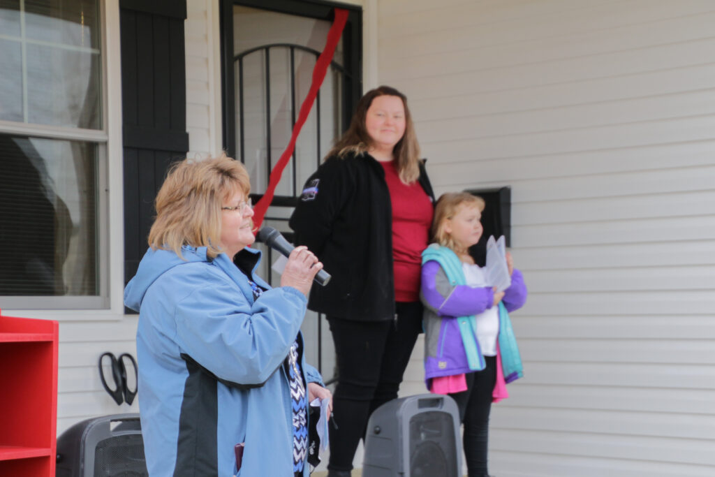 Beth Folz, left, executive director of Habitat for Humanity-Evansville, talks about the St Theresa Place subdivision as new homeowner Sarah and her daughter Wyllow listen. The Message photos by Tim Lilley