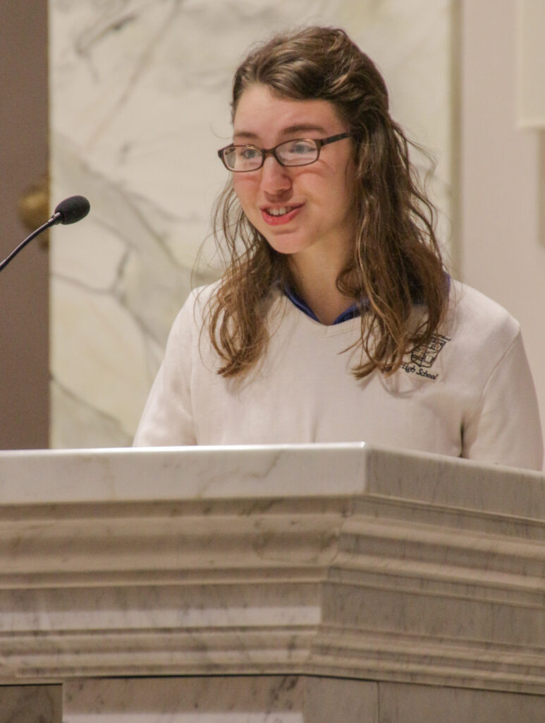 Kate Schadler of Reitz Memorial High School served as reader during the Mass. The Message photo by Tim Lilley