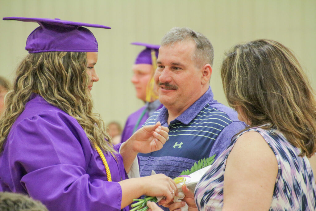 Alicia McGuire, left, one of Rivet High School’s four valedictorian, presents a bouquet of flowers to her
parents in thanksgiving for all they have done for her. Seniors at the Vincennes Catholic high school have
carried on this tradition for many years. Rivet held its Commencement ceremony for the class of 2022
May 21.
The Message photo by Tim Lilley