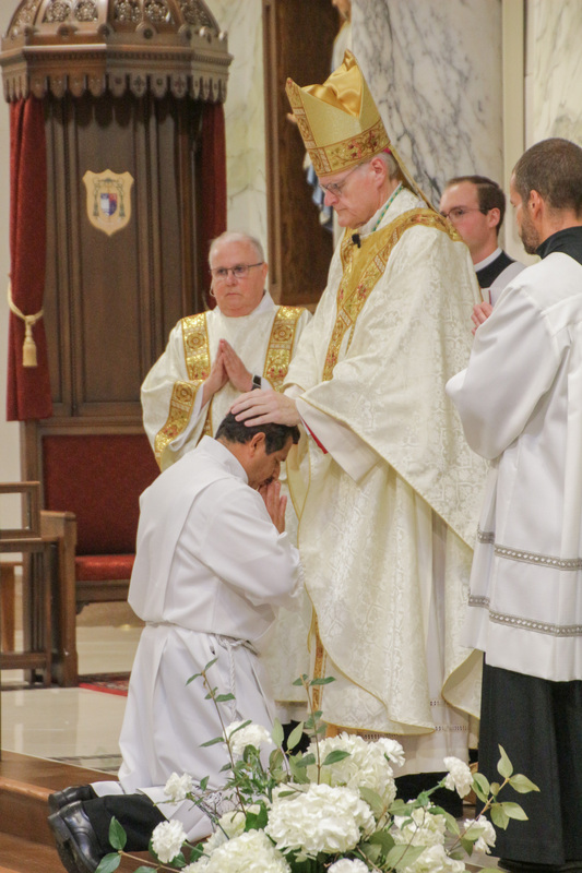 Bishop Siegel lays his hands on candidate Jorge Melendres as he ordains him a Deacon. The Message photo by Tim Lilley