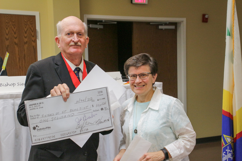 Benedictine Sister Anita Louise Lowe, right, Prioress of the Sisters of St. Benedict of Ferdinand, accepts a $1,000 donation from Jasper Council #1584 Grand Knight Joe Buechlein. The Message photo by Tim Lilley