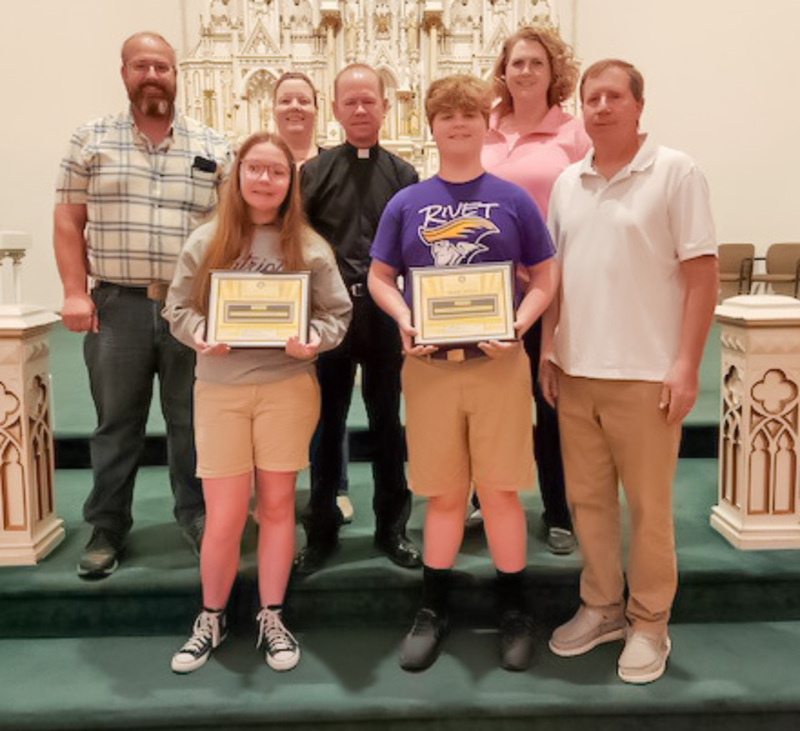 Youth Service Aware honorees from Rivet Middle School in Vincennes include Madison Will, front row left and Max Weiss. Also shown are their parents and pastor - David Weiss, front row right,  Jeremy Will, back row left, Sarah Will, St. Francis Xavier Parish Pastor Father Tony Ernst and Molly Weiss. Submitted photo