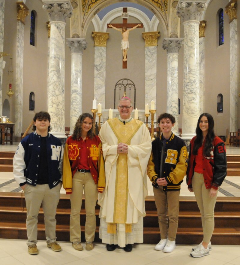 Students from the Diocese of Evansville’s four Catholic high schools pose for a photo with Bishop Joseph M. Siegel before he celebrated the 2024 Catholic Schools Week Mass at St. Benedict Cathedral in Evansville. About 20 priests of the diocese, representing parishes with Catholic schools, concelebrated. Shown are Levi Holden, left, Reitz Memorial High School in Evansville; Mary Beth Sullivan, Mater Dei High School in Evansville; Bishop Siegel; Mason Trent, Rivet High School in Vincennes; Audrey Jerger, Washington Catholic High School in Washington. Students in the highest grade level of each of the diocese’s 26 Catholic schools attended Mass. National Catholic Schools Week annually celebrates Catholic education in the United States. It starts the last Sunday in January and runs all week, which in 2024 is Jan. 28 through Feb. 3. Complete coverage of the Mass will appear in the Feb. 9 issue of The Message.


The Message photo by Megan Erbacher
