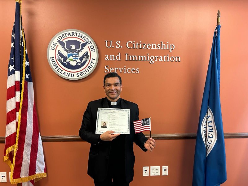 Father Benny Alikandayil Chacko, pastor of Annunciation Parish in Evansville, holds an American flag as a new United States citizen following a Jan. 22 citizenship interview and oath ceremony in Indianapolis. Congratulations, Father Benny, on becoming a naturalized citizen of the U.S.! Submitted photo courtesy of Father Benny Alikandayil Chacko